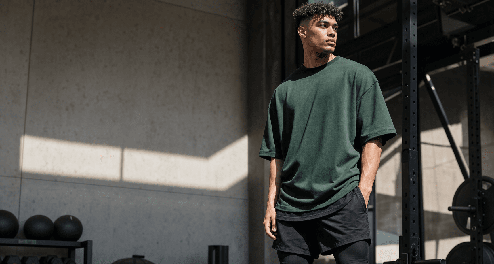 Bottle green oversized Pump Cover tee in a gym setting